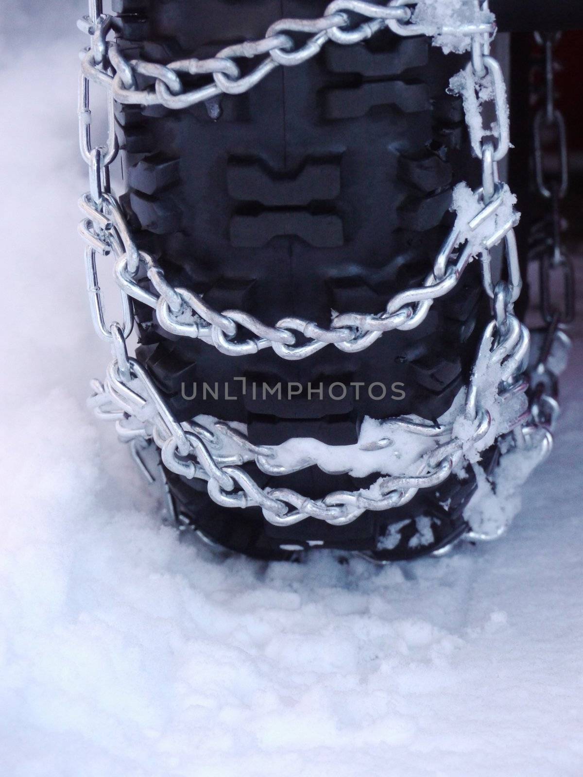 Snow chains outside at a wheel in winter