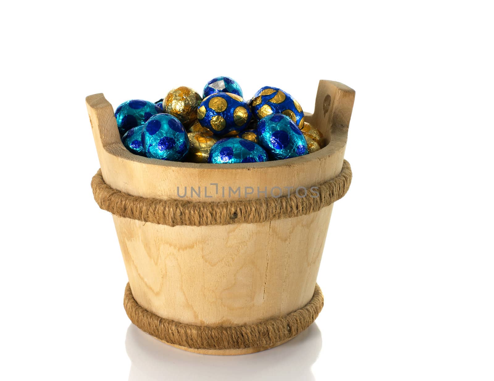 wooden bucket with easter eggs isolated on white