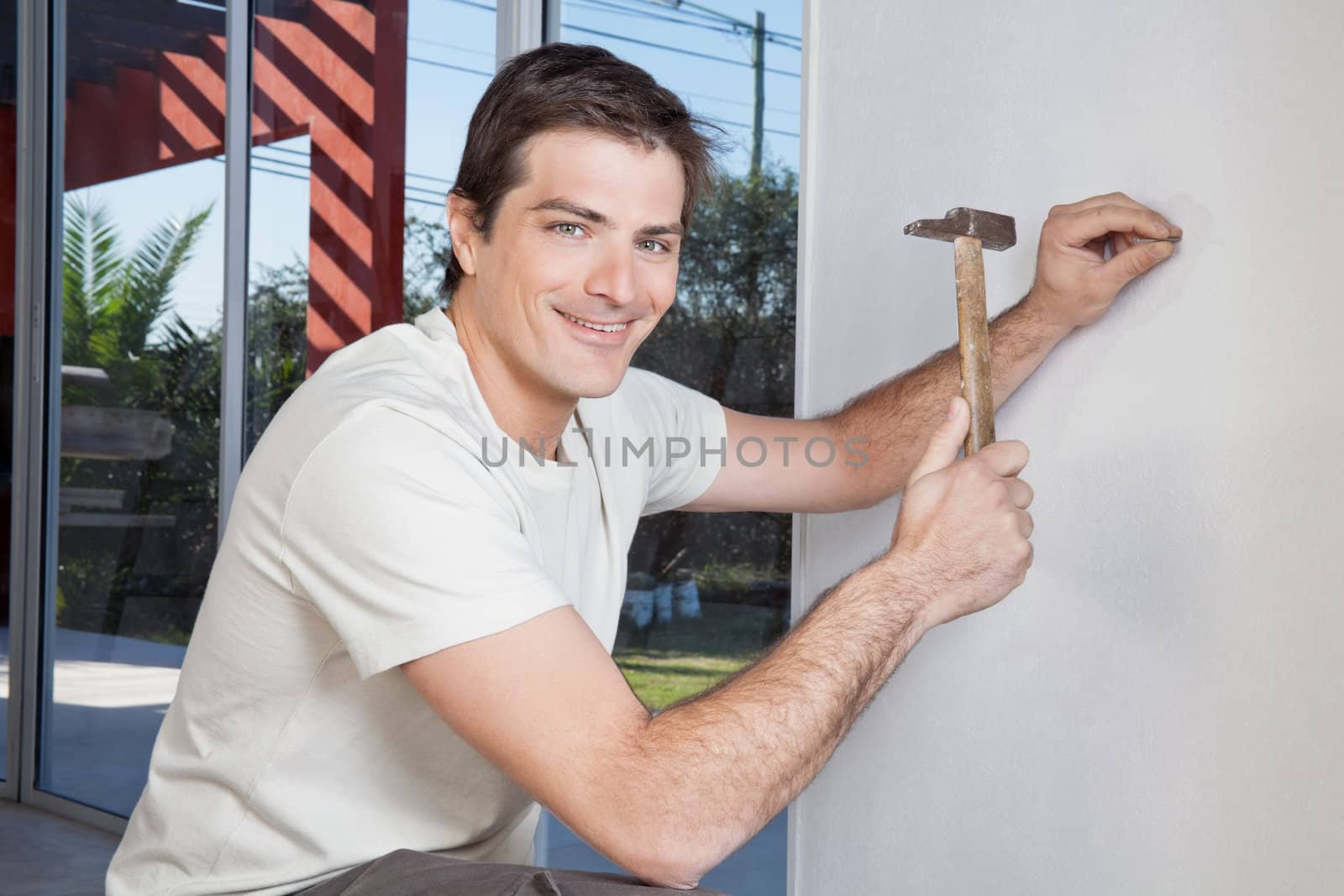 Man hammering the wall by leaf