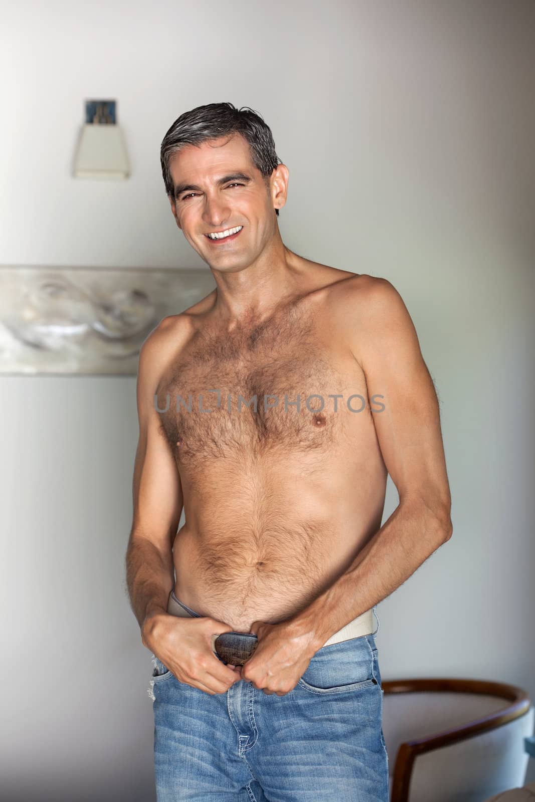 Portrait of handsome shirtless middle aged man smiling