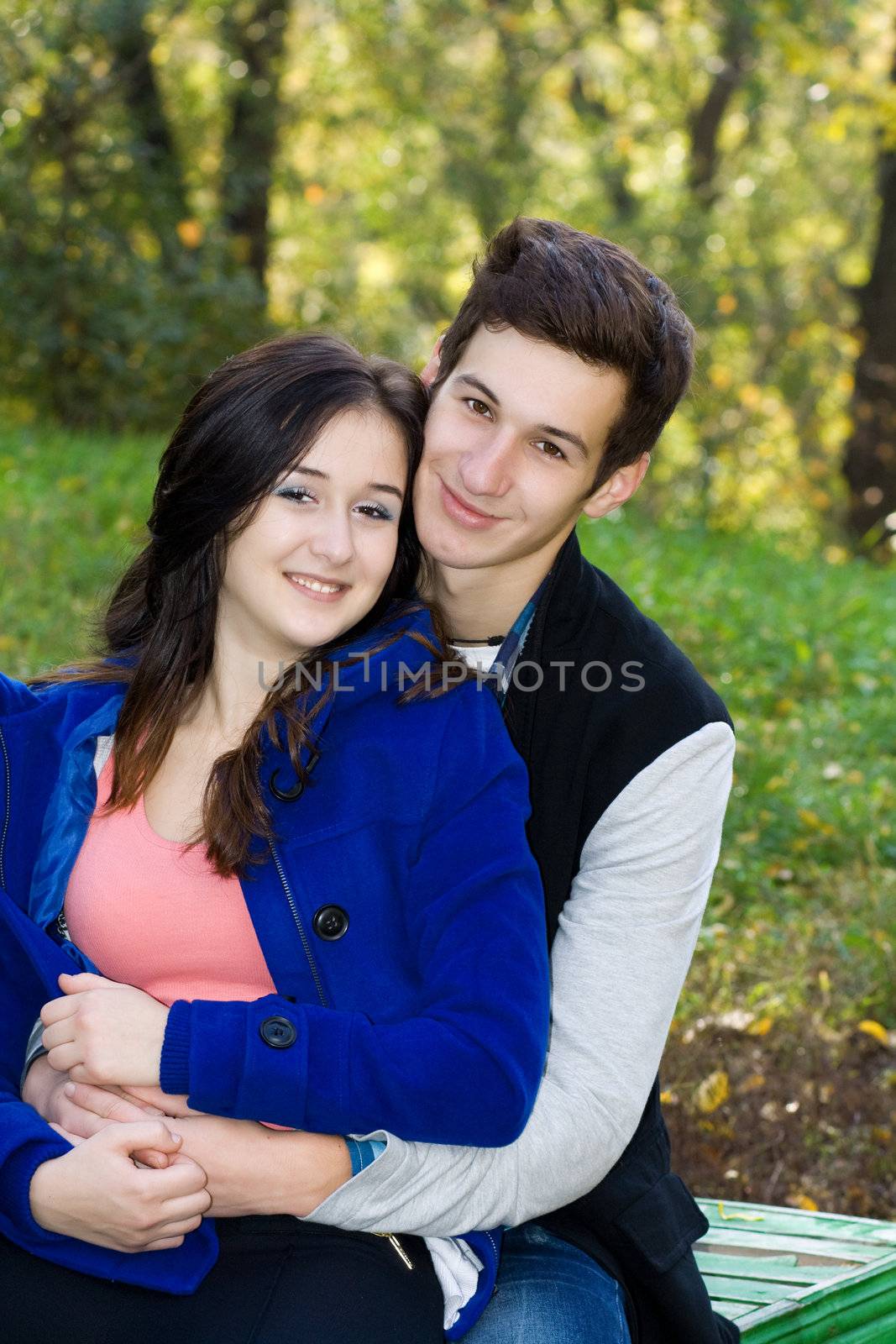 Young men embraces beautiful girl