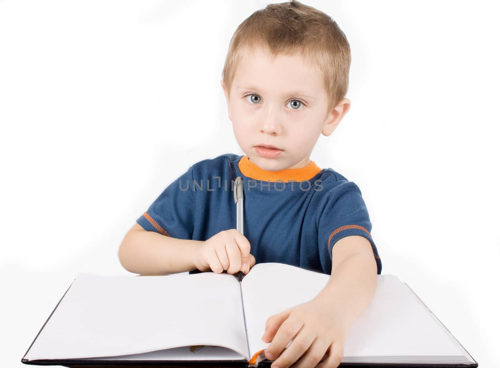 Boy with the pen writes in a notebook