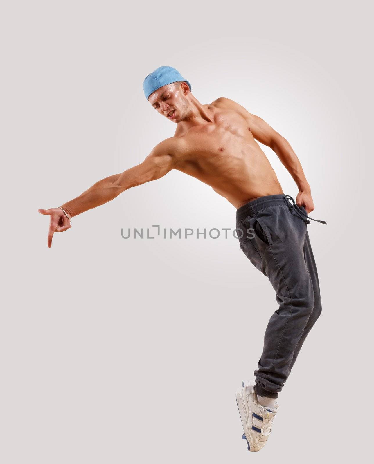 young man in a blue cap dancing hip hop