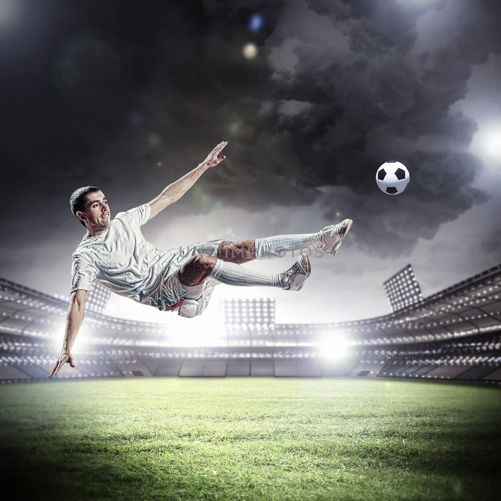 football player in white shirt striking the ball at the stadium