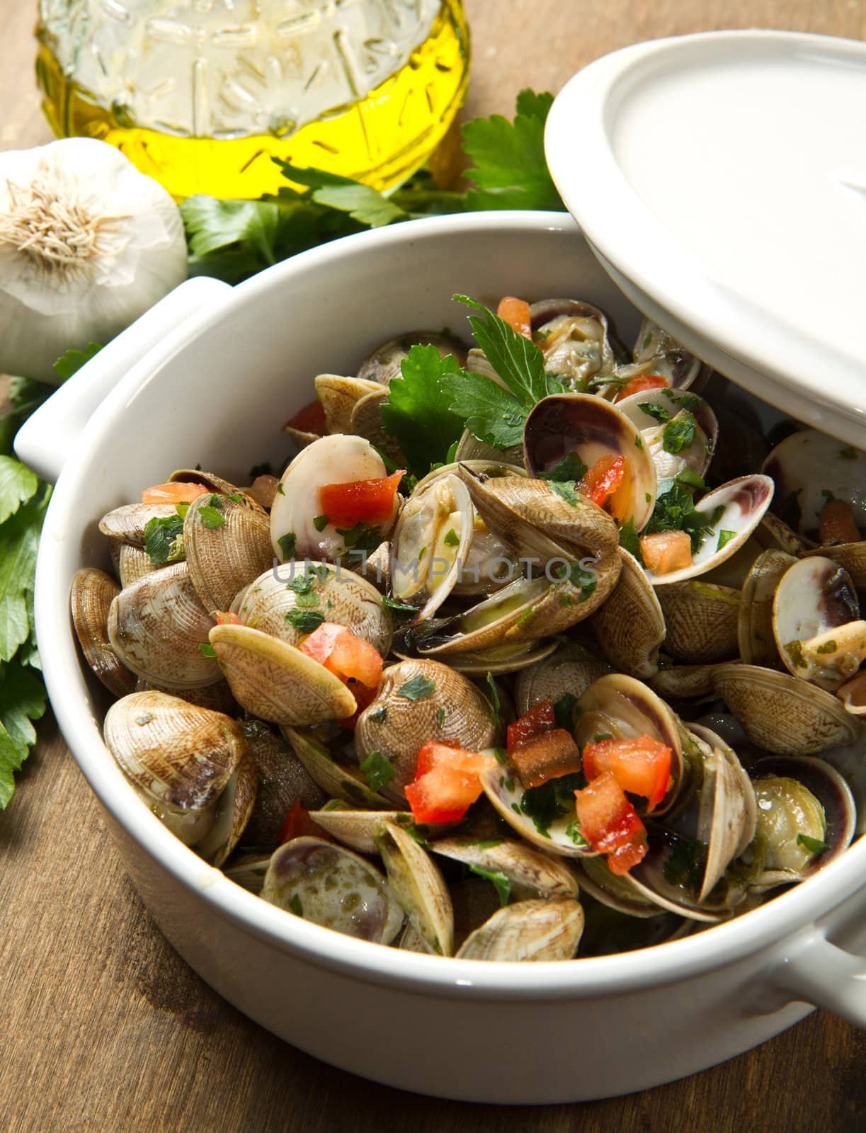 bowl with delicoius clams soup on wooden table