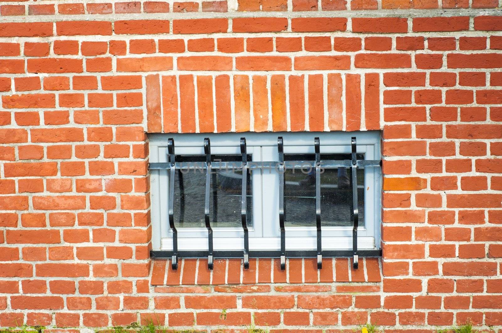 An image of jail window with grille