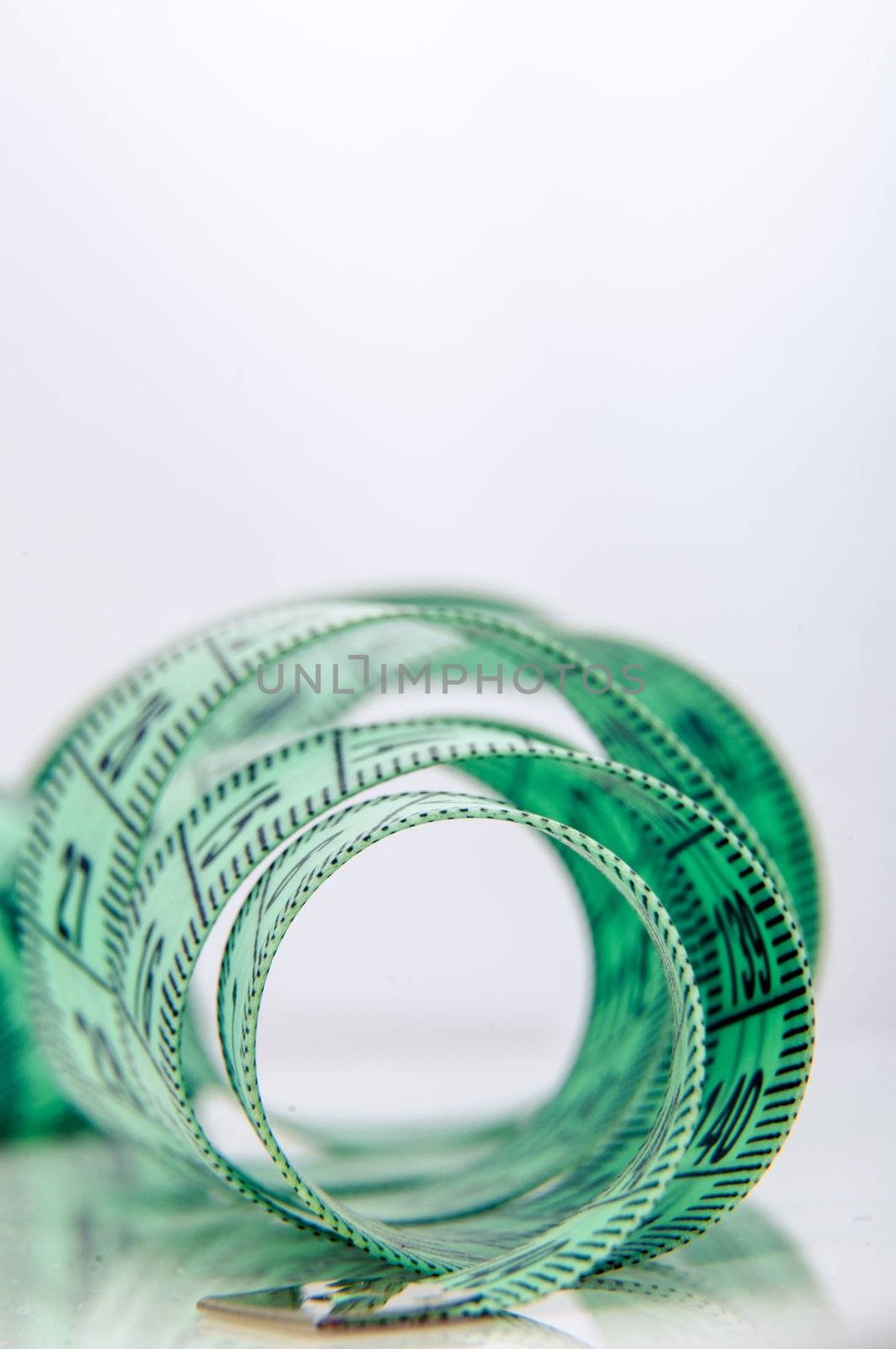 An image of green centimeter on white background