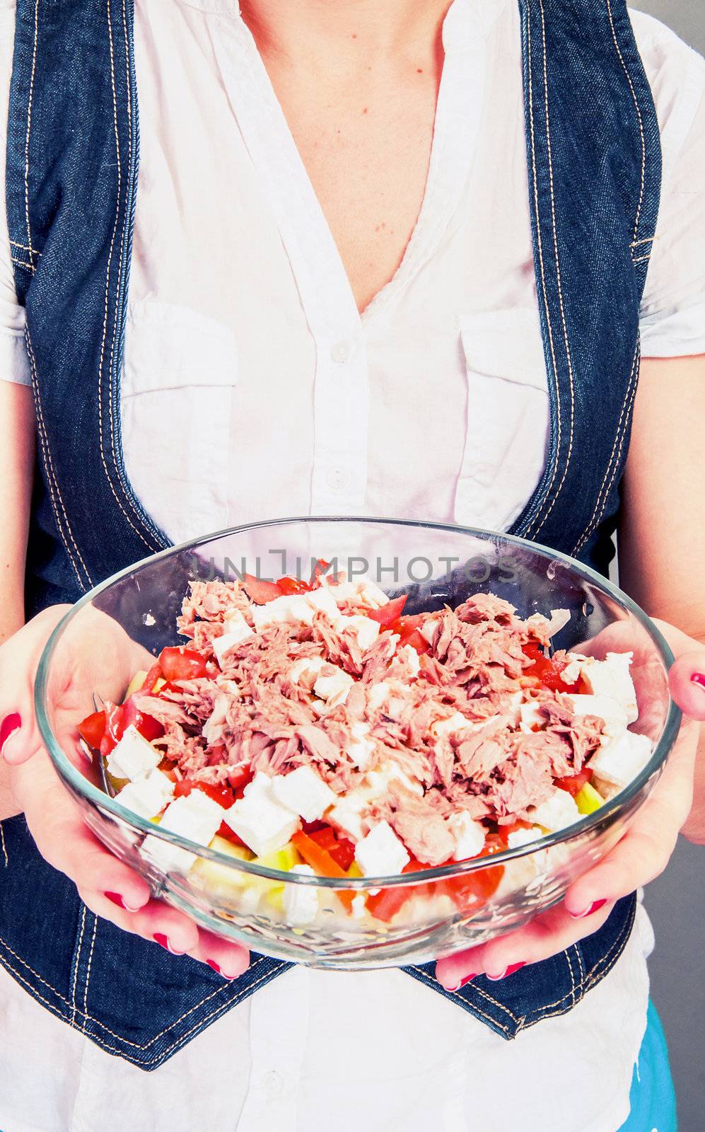 An image of girl holding tuna salad in salad bowl