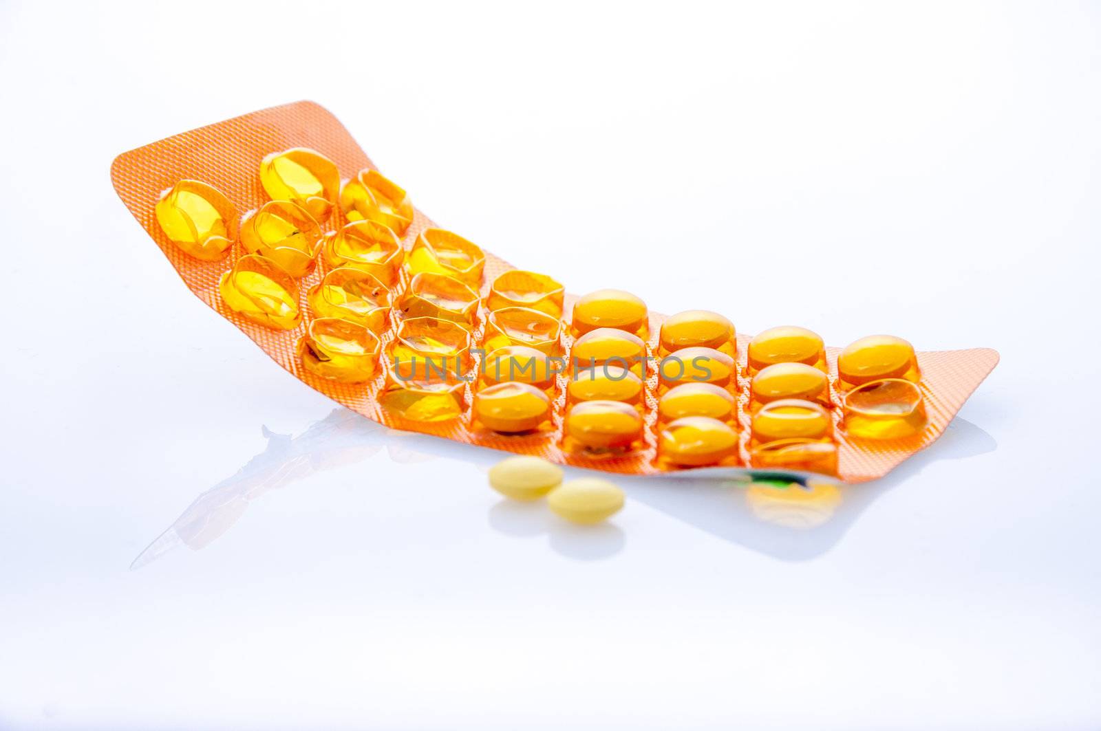 an image of orange pills isolated on white