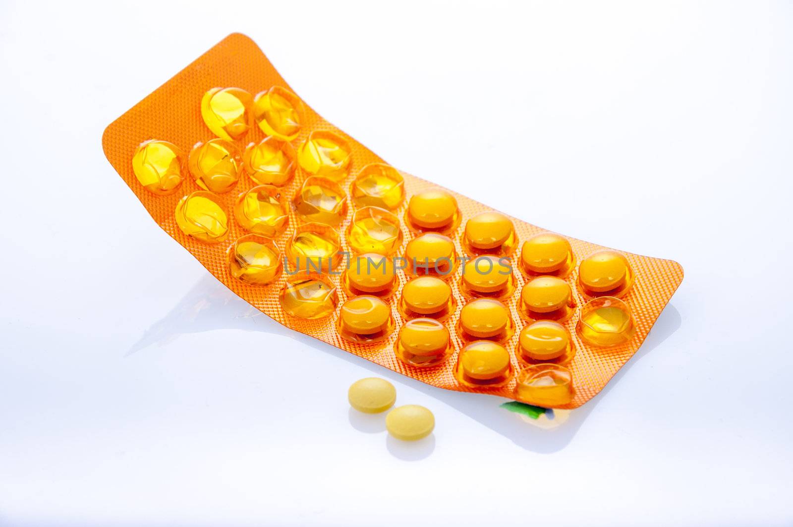 an image of orange pills isolated on white
