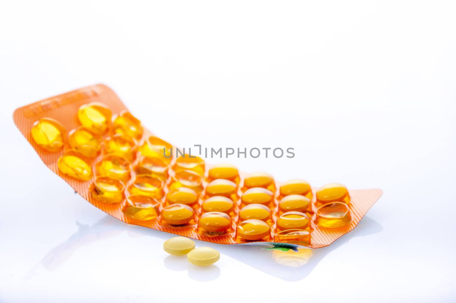 an image of orange pills isolated on white