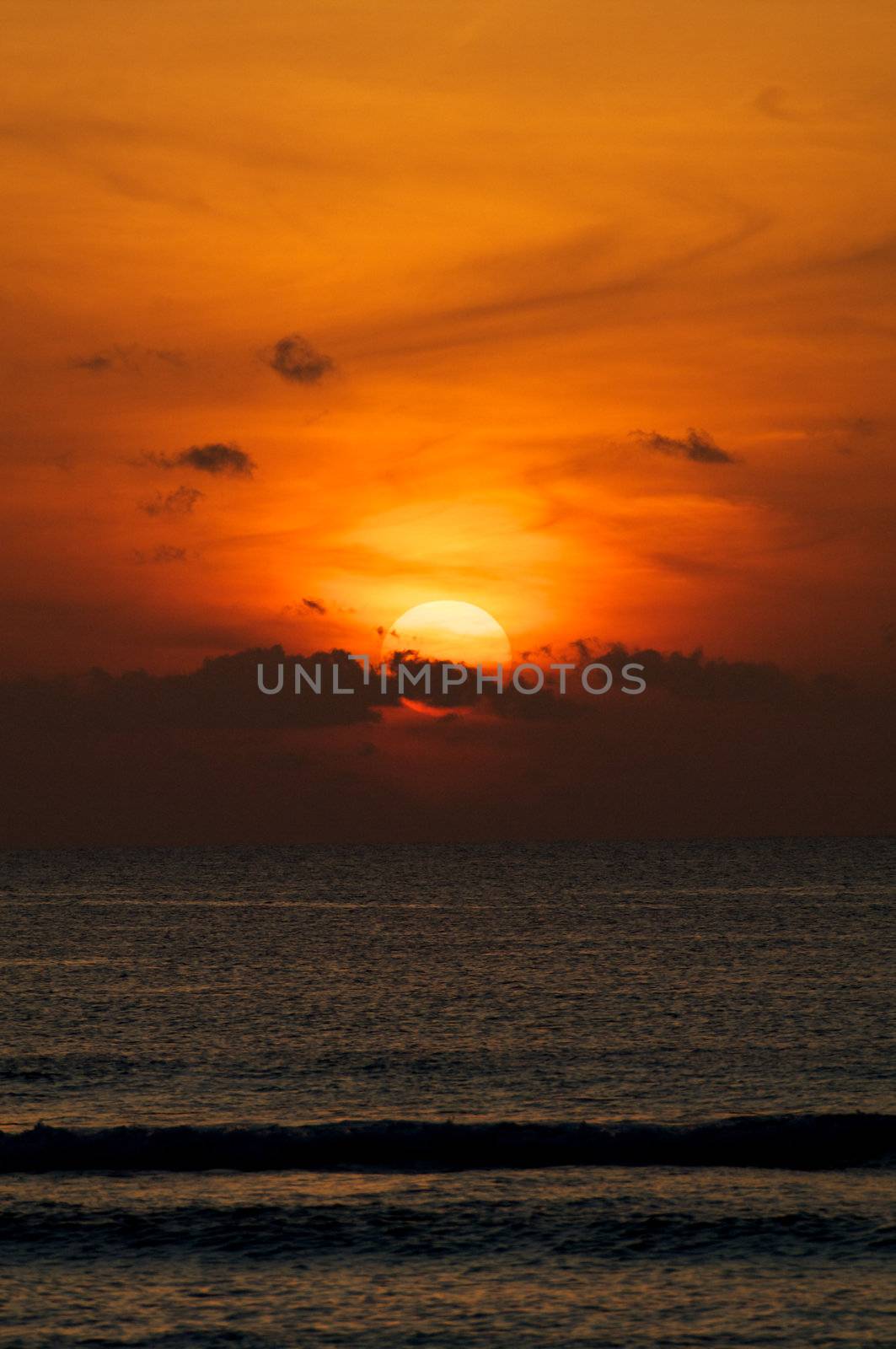 Red Sunset on Indian Ocean over Breaking Waves