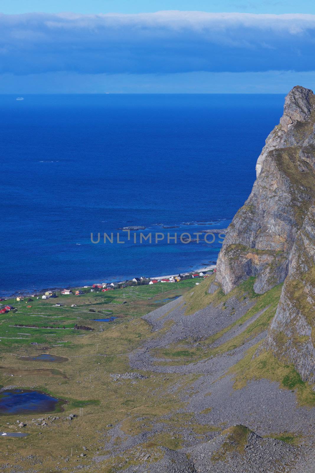 Aerial view of picturesque town Nordland below tall cliffs on Lofoten islands in Norway