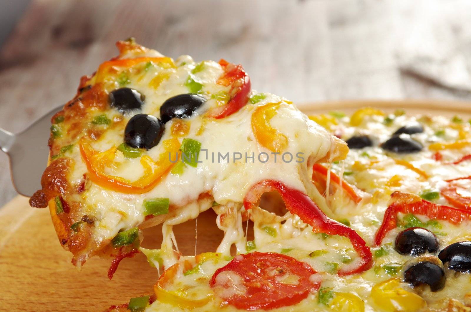 home pizza with tomato and eggplant  Closeup .taking slice of pizza,melted cheese dripping