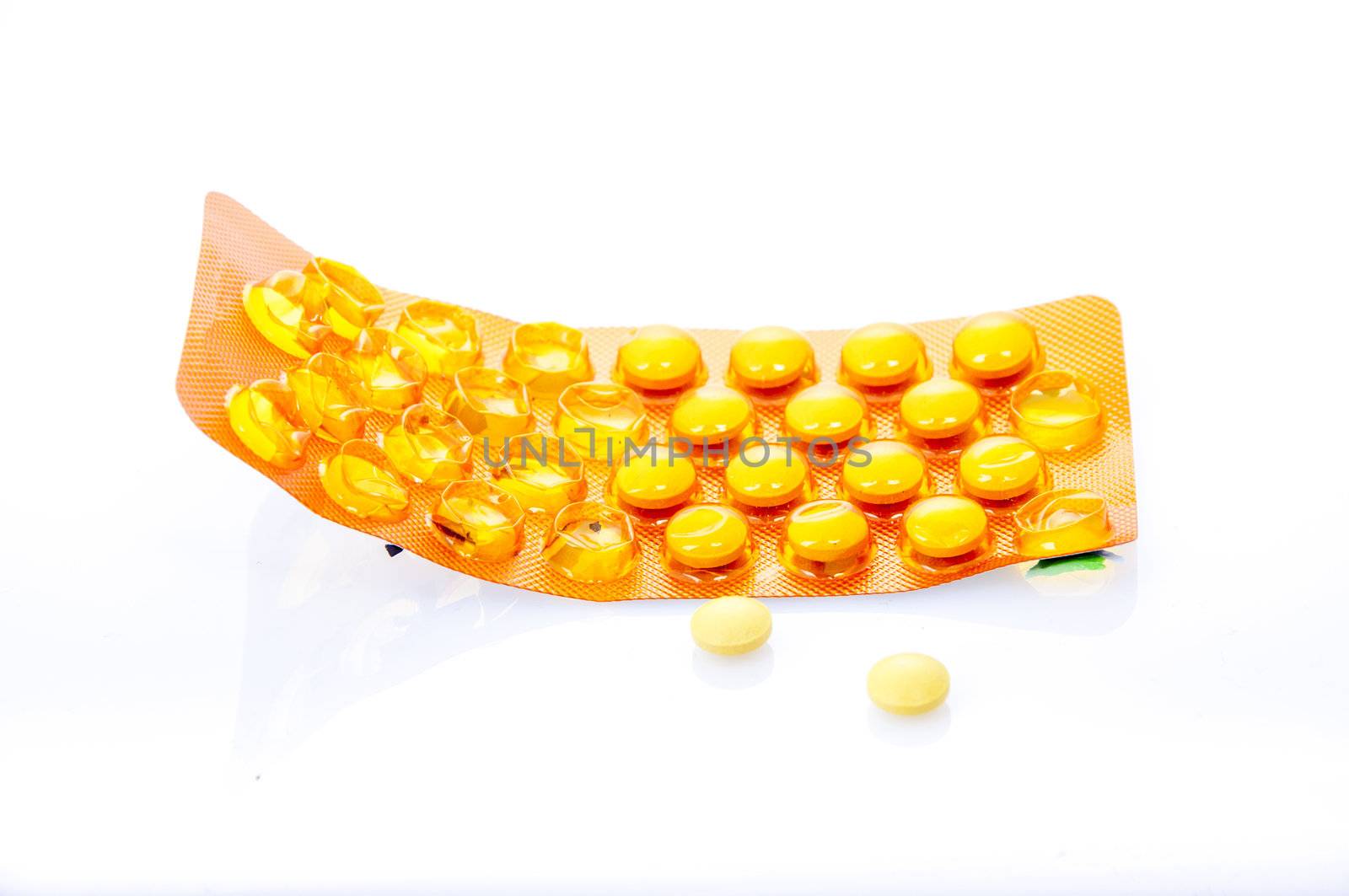 an image of orange pills isolated on white