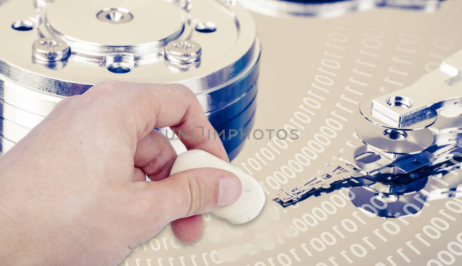 an image of hand with eraser removing data from hdd