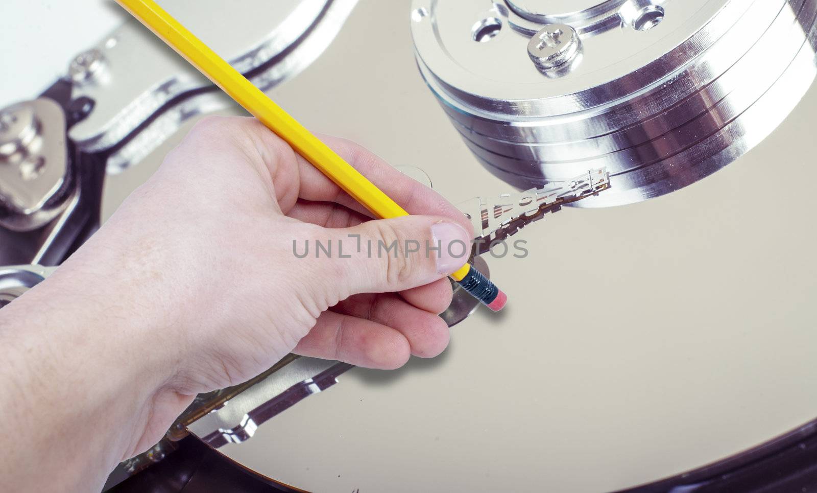 an image of hand with eraser removing data from hdd