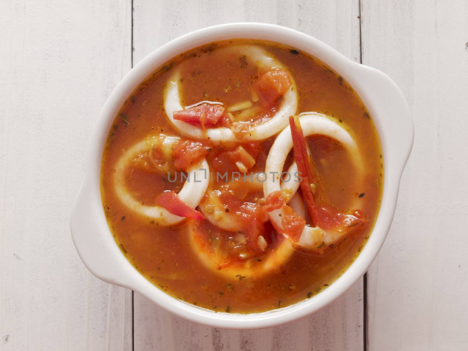 close up of a bowl of calamari seafood soup