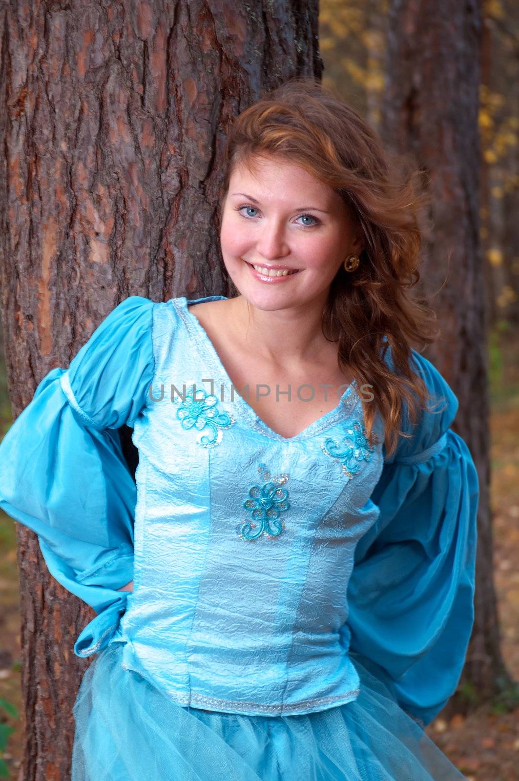 Very beautiful girl in medieval dress in autumn wood