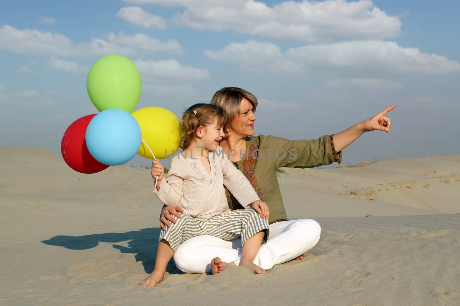 happy mother and daughter with colorful balloons