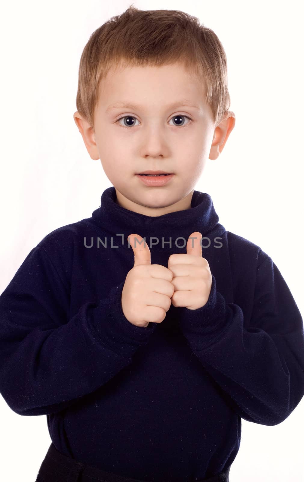 Happy boy shows the sign OK on a white background