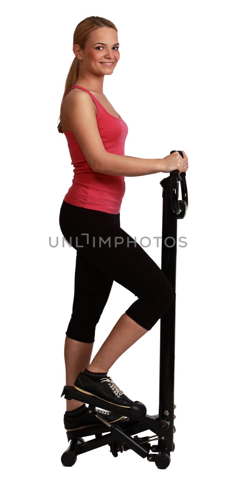 Young smiling blonde woman exercising on a stepperagainst a white background.