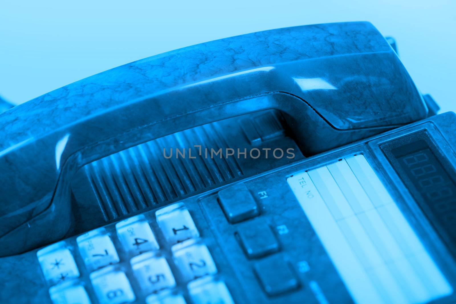 The dark blue telephone on a blue background