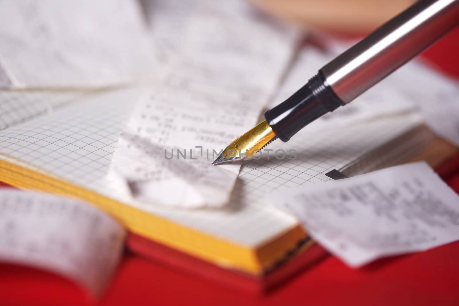 Pen and bank bills on a table at office