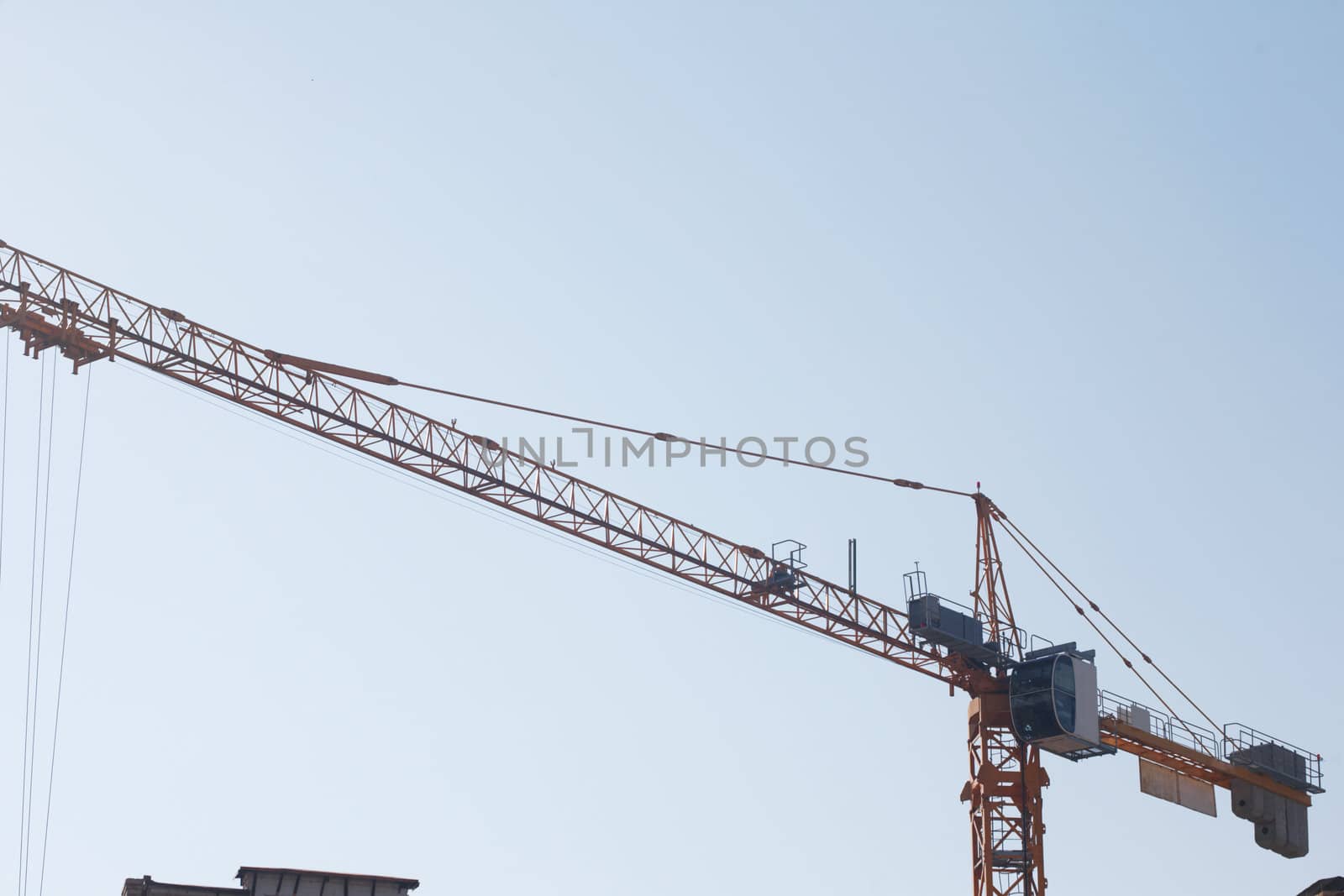 The elevating crane on construction of a building