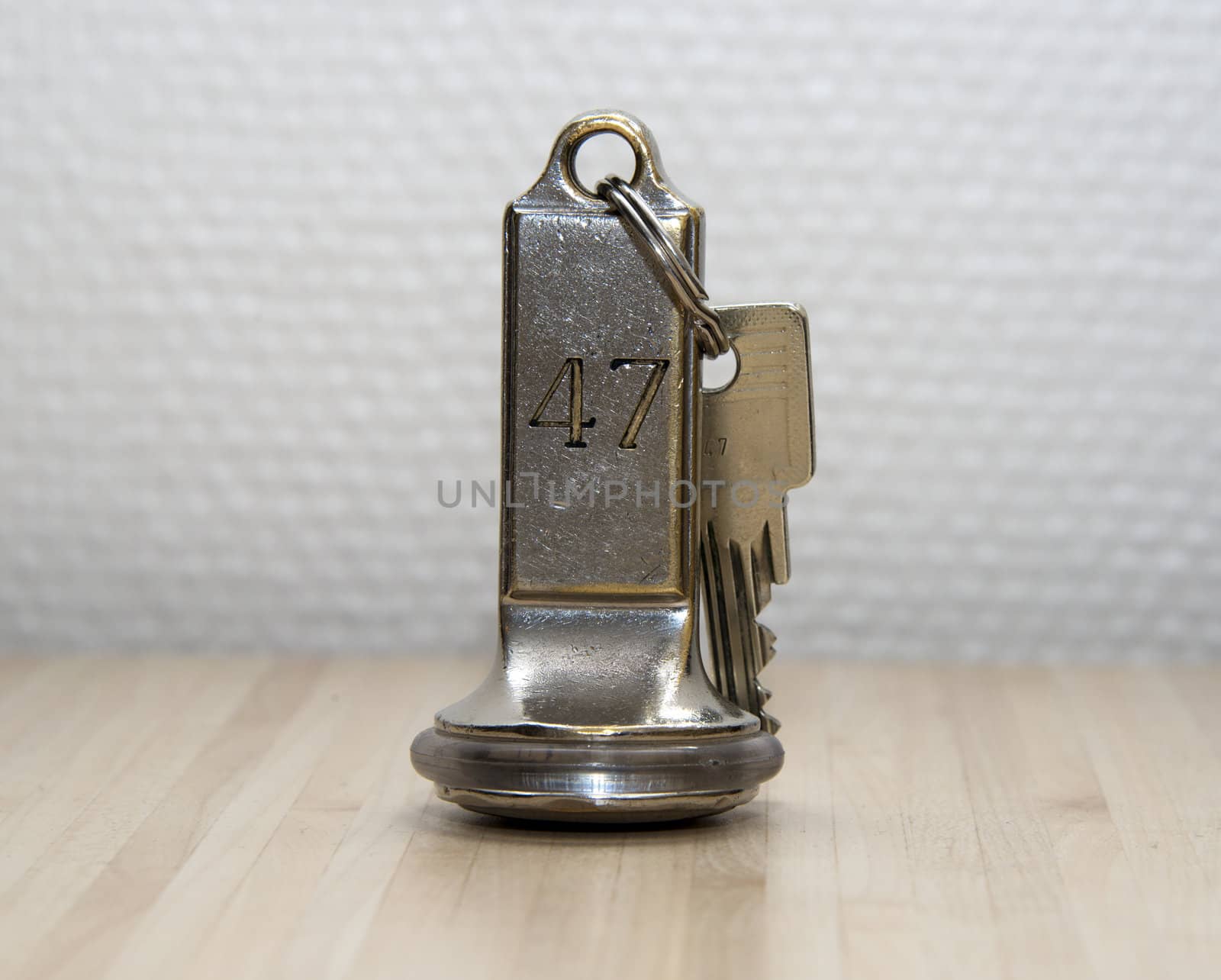 hotel key number forty seven on wooden table