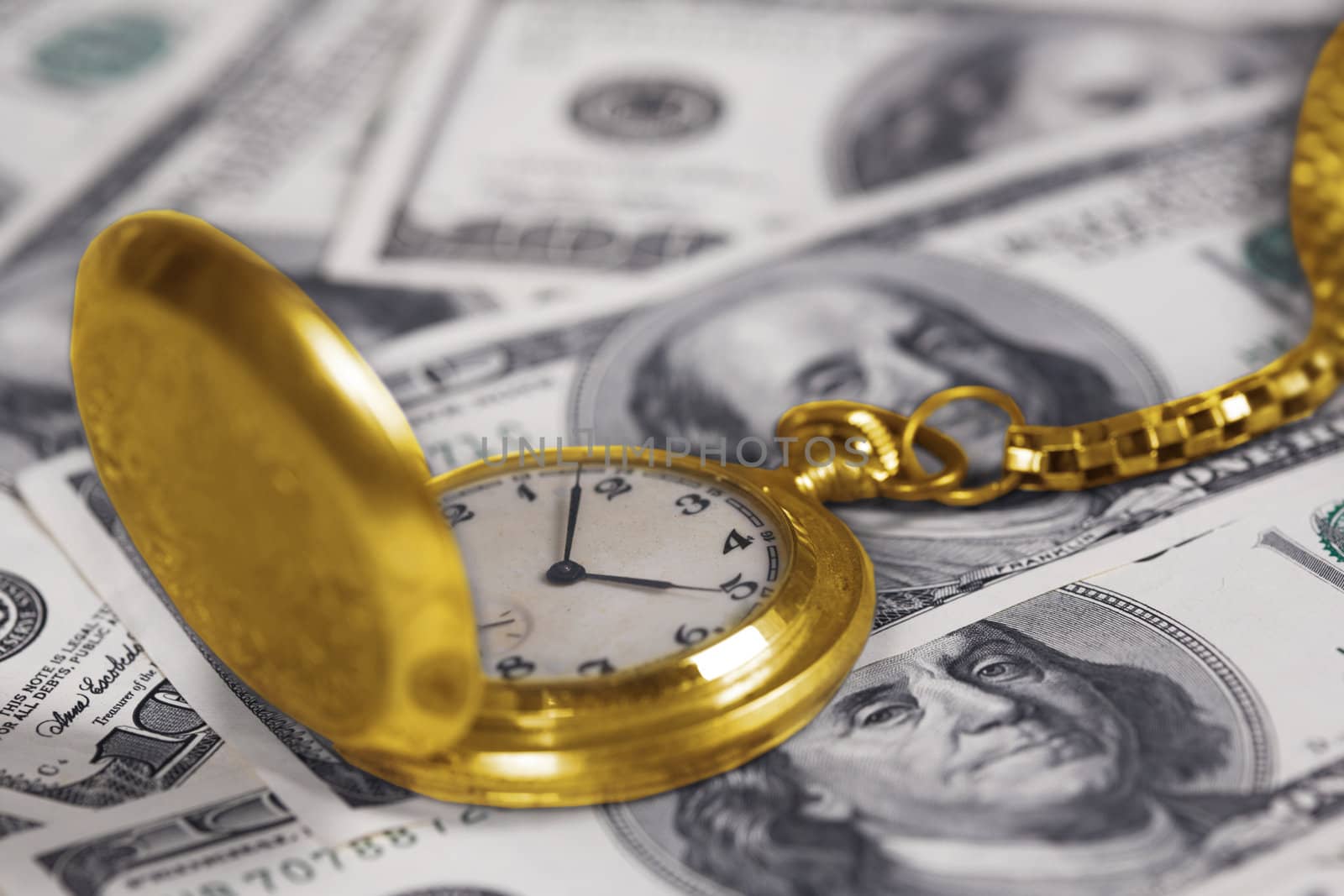 Gold clock with a watch-chain and dollars
