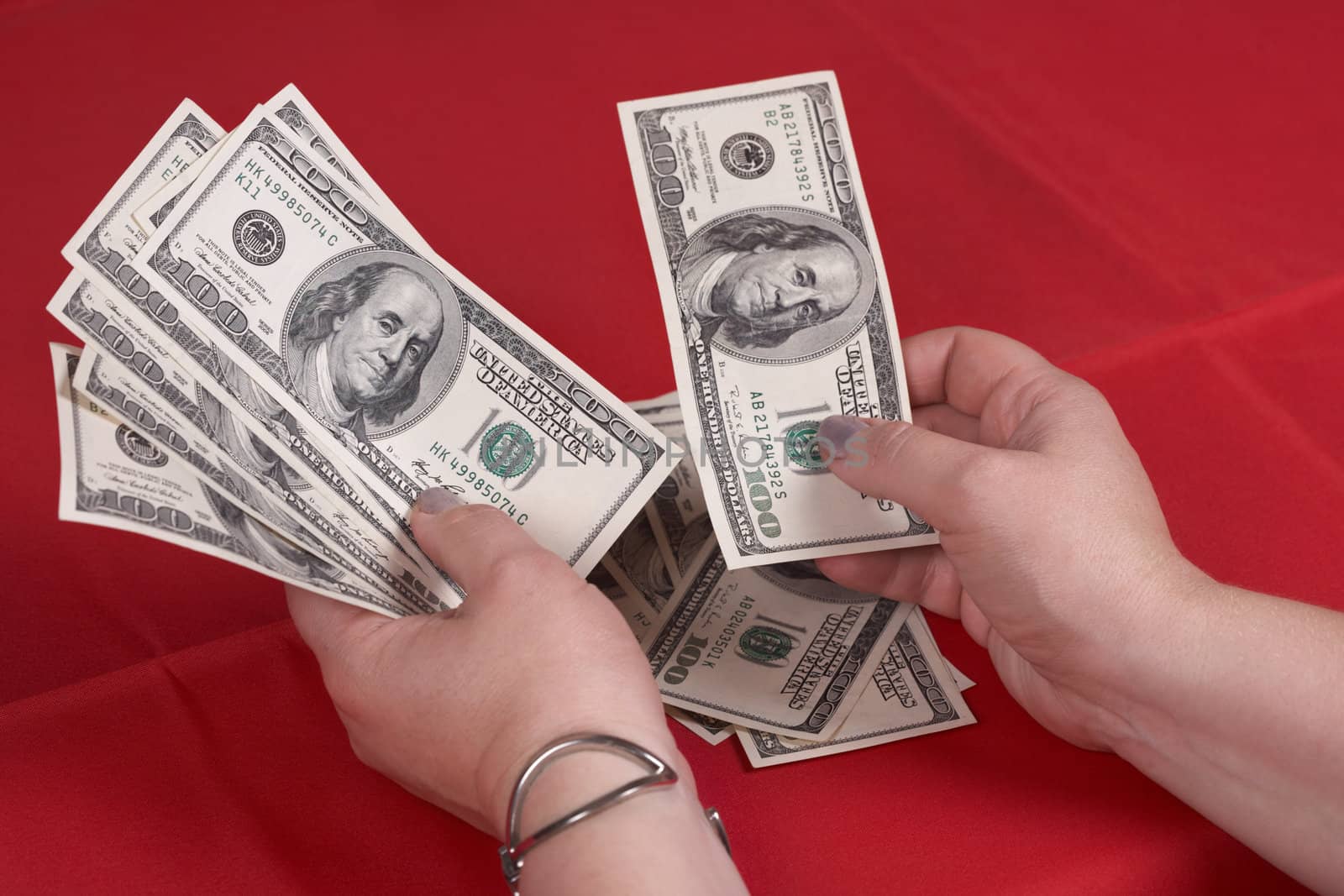 Hands and dollars on a red background