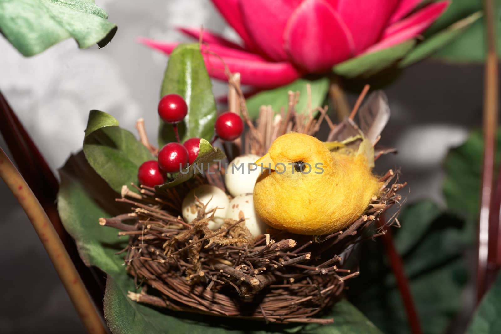 Bird's-nest. A yellow bird and red flower
