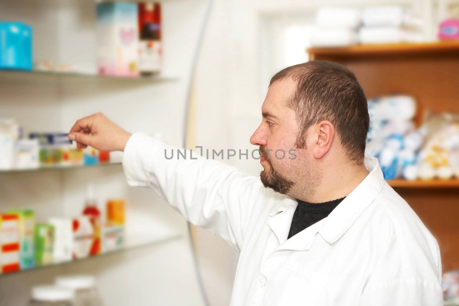 Portrait of a male pharmacist at pharmacy. Medicine 