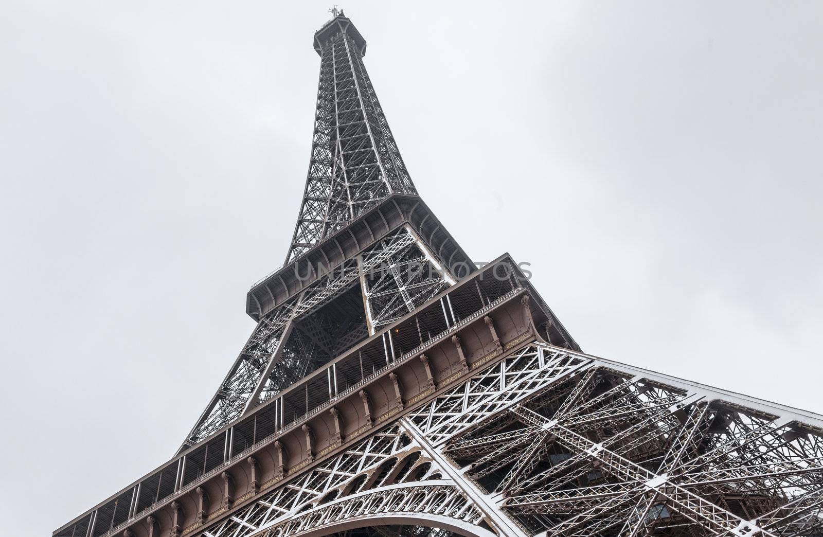 Detail of the Eiffel Tower covered by snow during the winter.