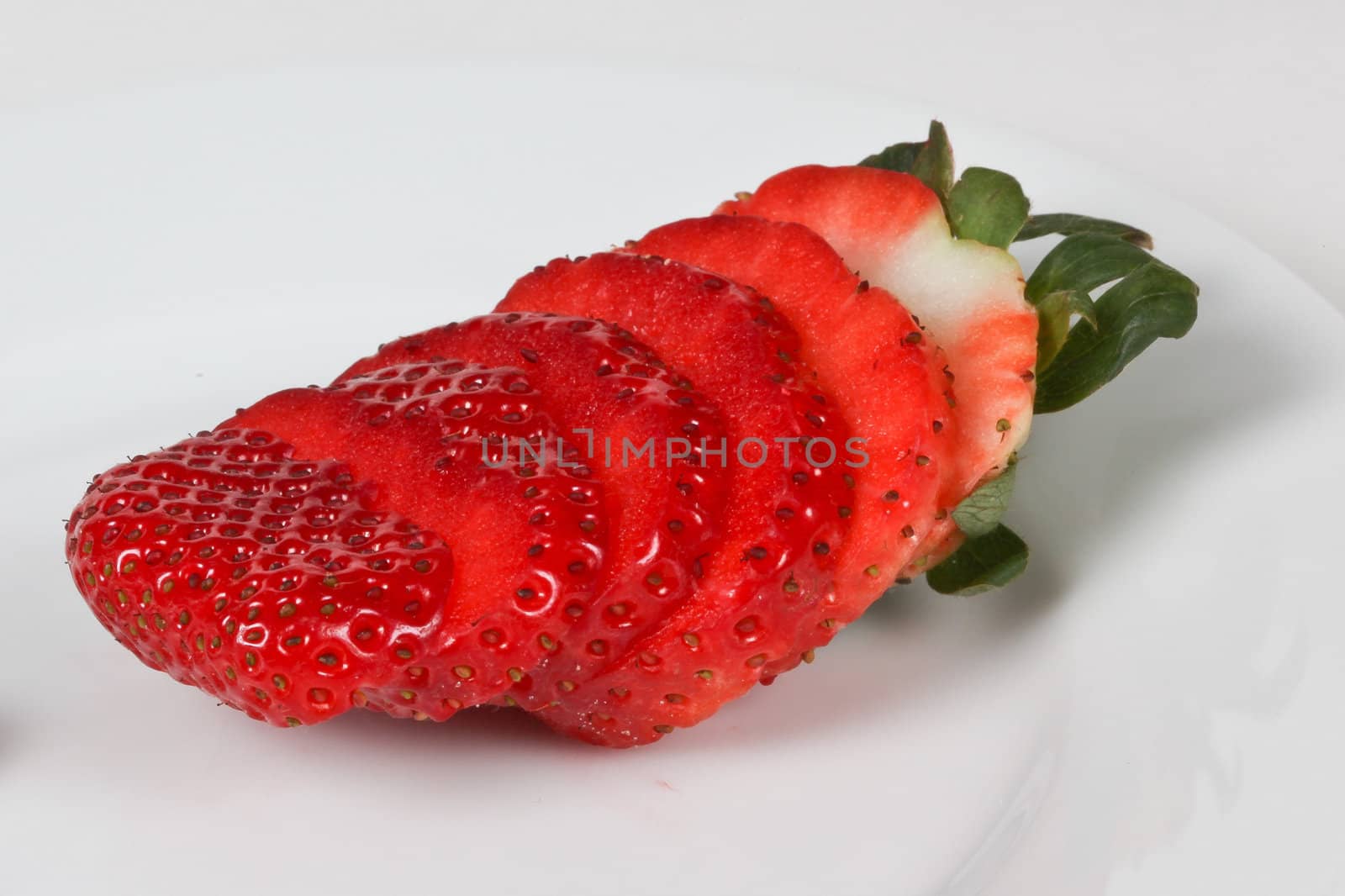 Sliced strawberry on white plate