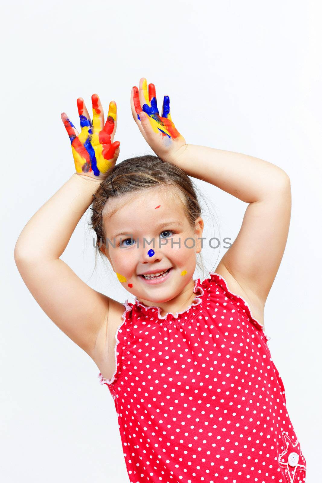 little child with hands painted in colorful paints ready for hand prints