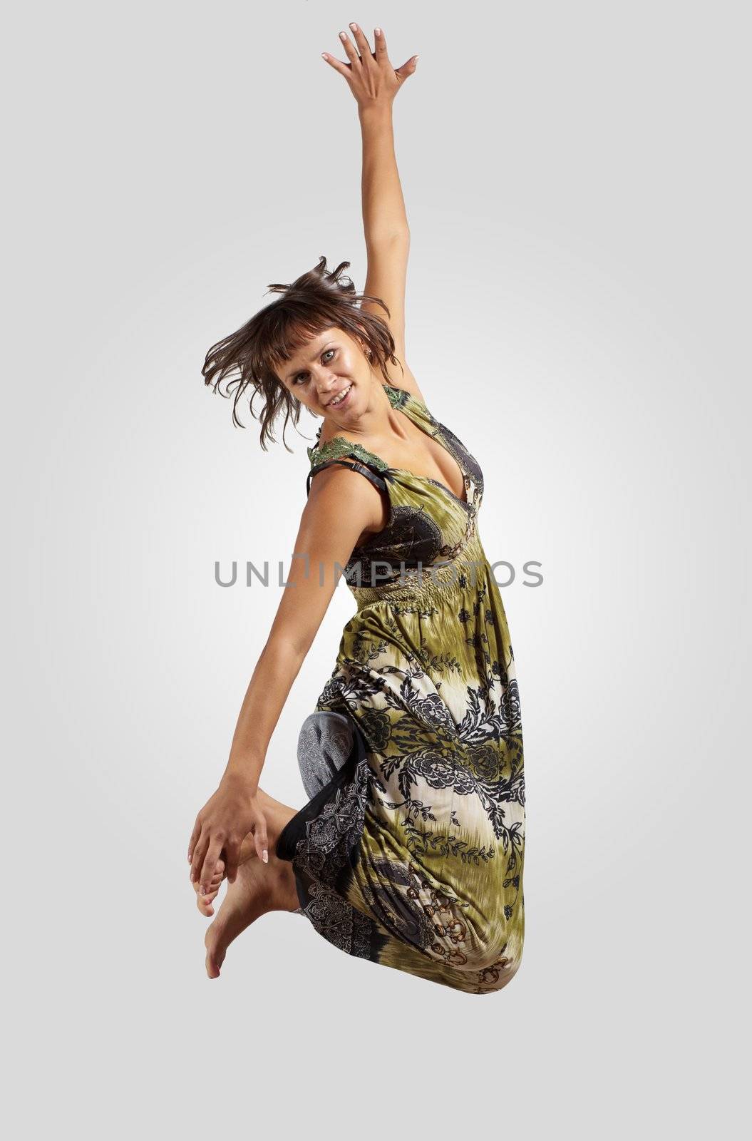 pretty modern slim hip-hop style woman jumping dancing on a grey background