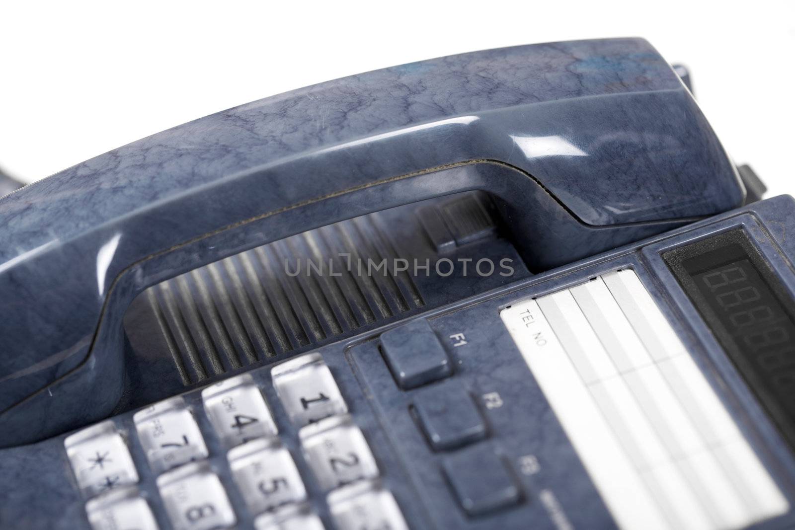 The dark blue telephone on a white background