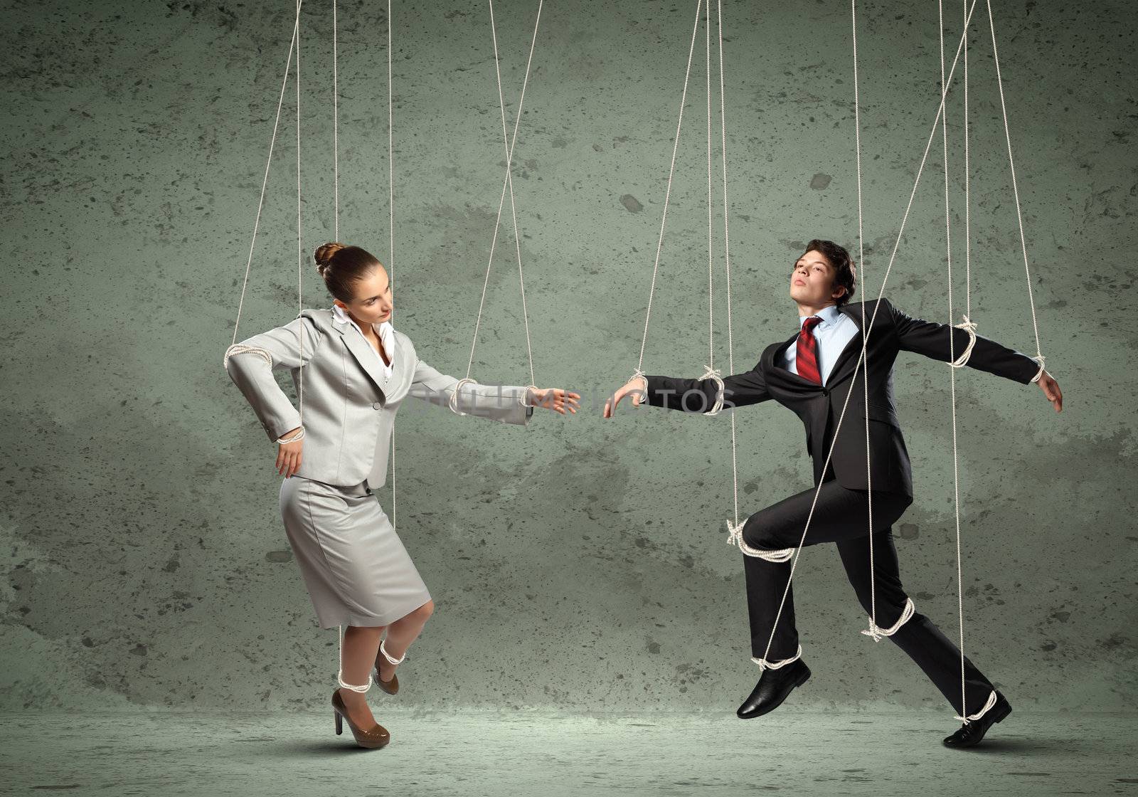 Image of businesspeople hanging on strings like marionettes. Conceptual photography