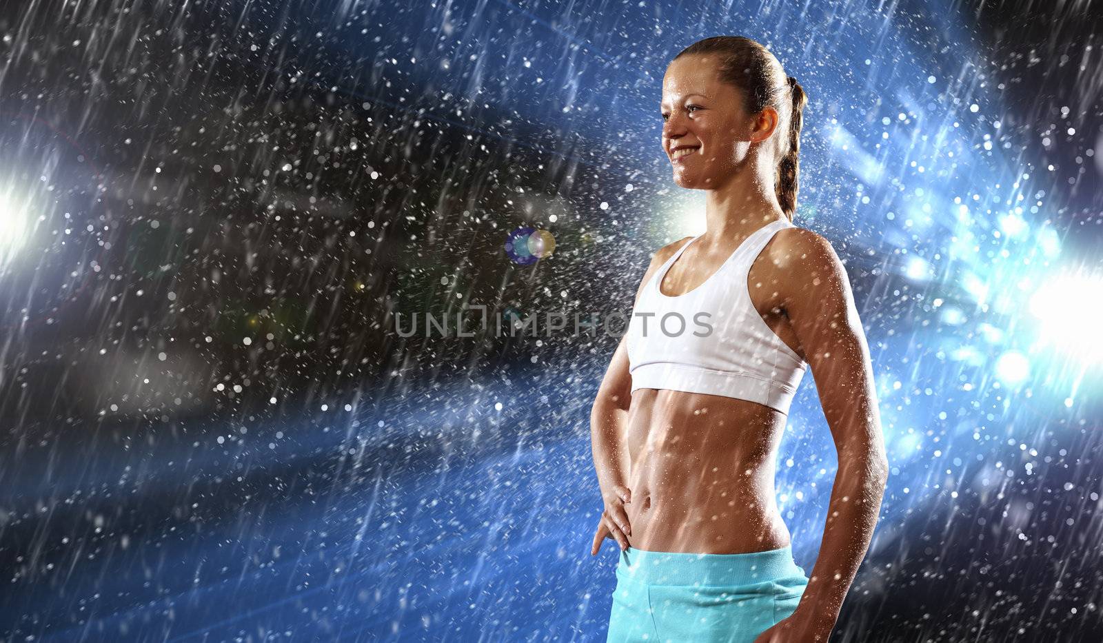 Fitness young woman standing under rain drops
