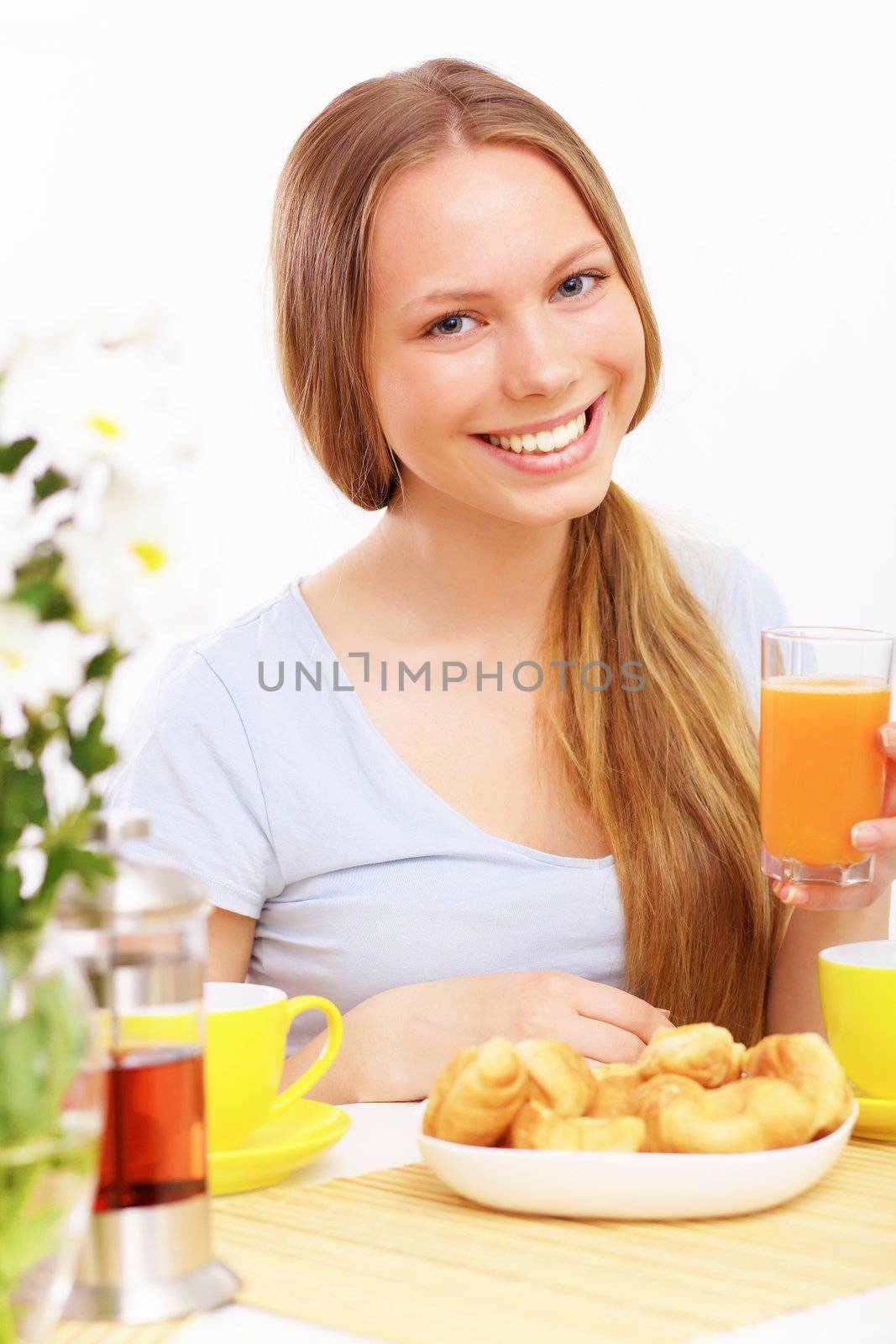 Beautiful young woman drinking tea from yellow cup