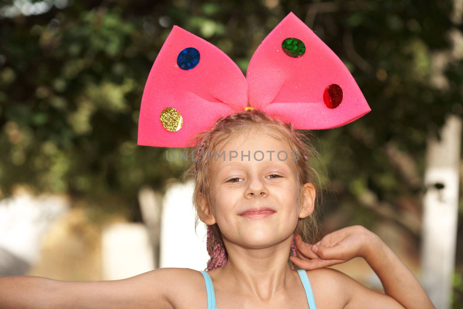 The the small girl with red bow on a head
