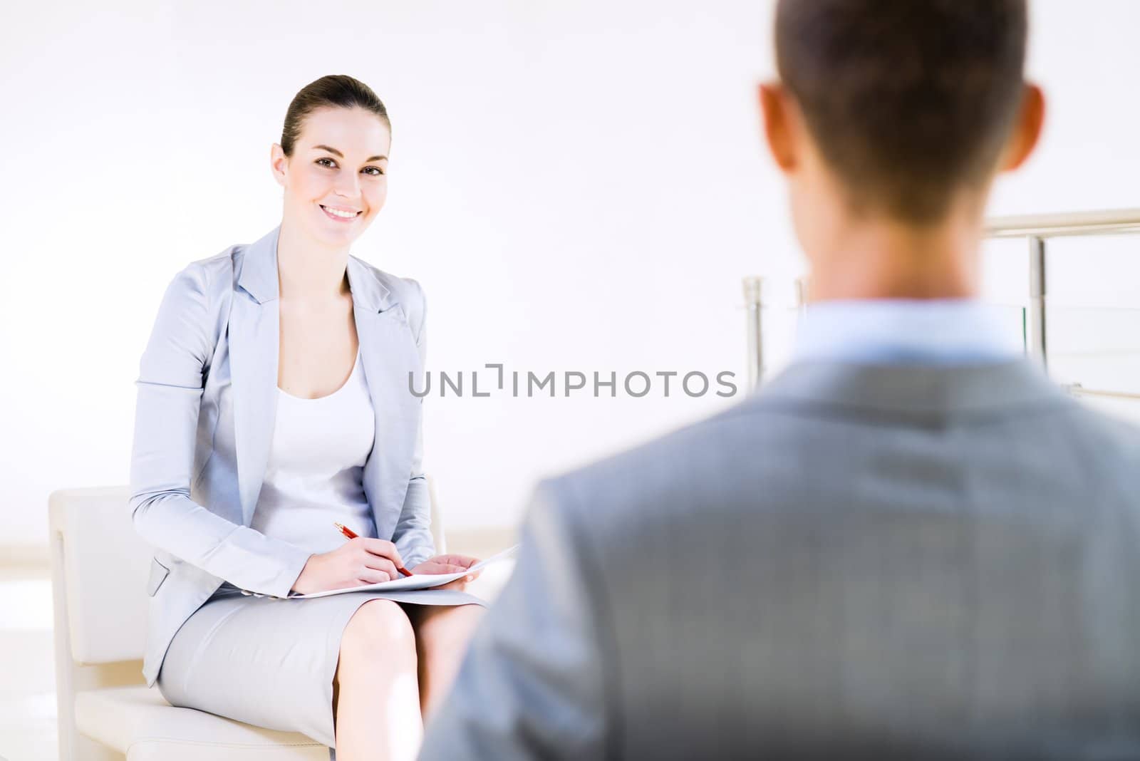 Business woman talking with a colleague in the office