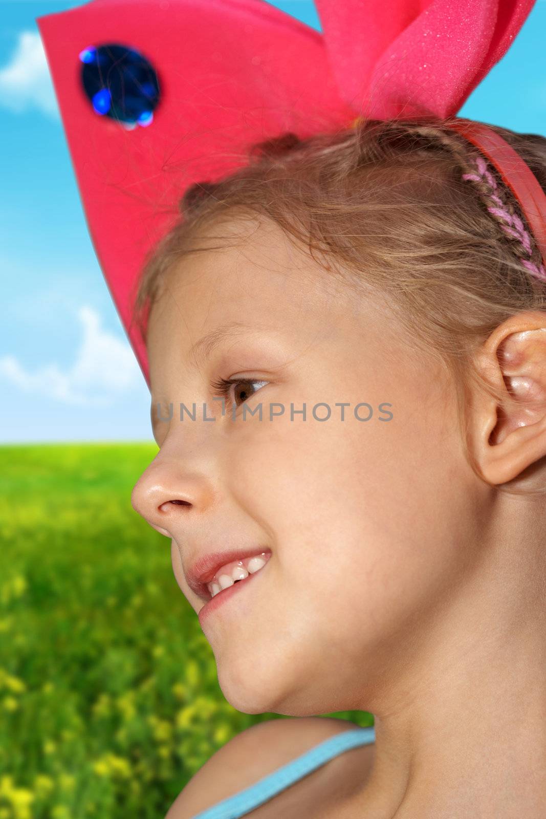 The the small girl with red bow on a head