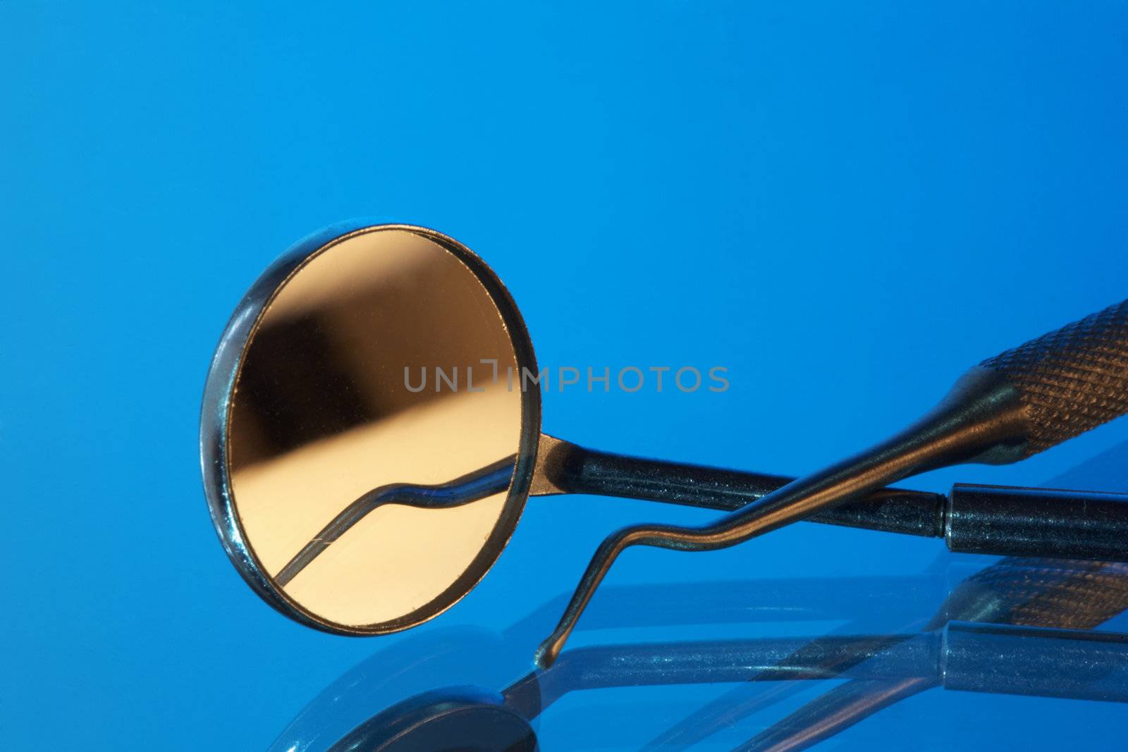 Set of dental tools on a blue background
