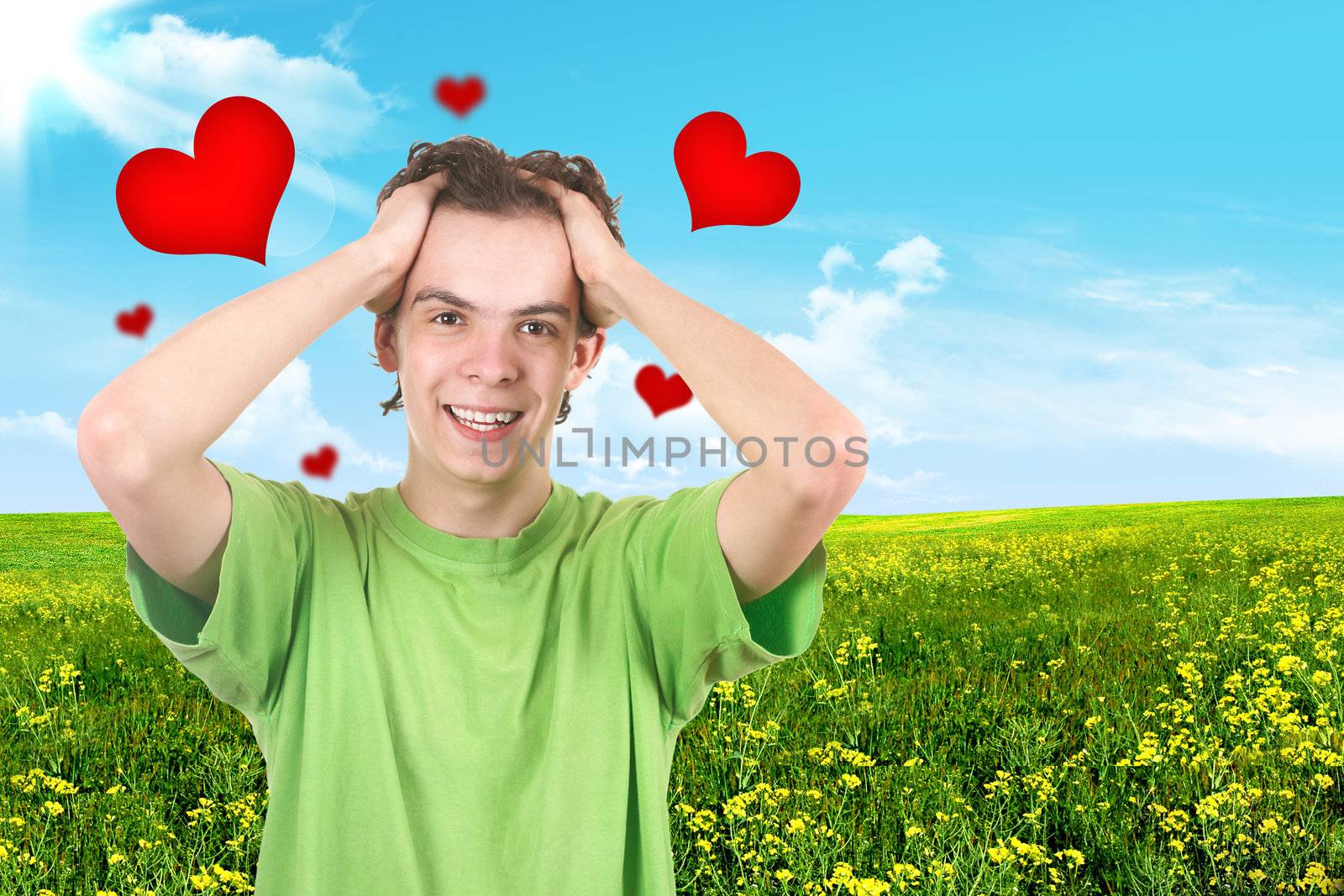 The joyful teenager on a green background. Hearts
