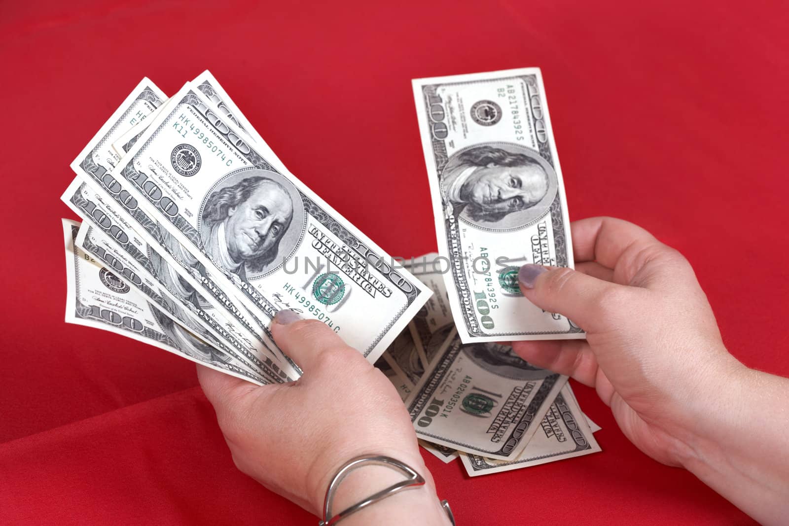 Dollars and hands on a red background