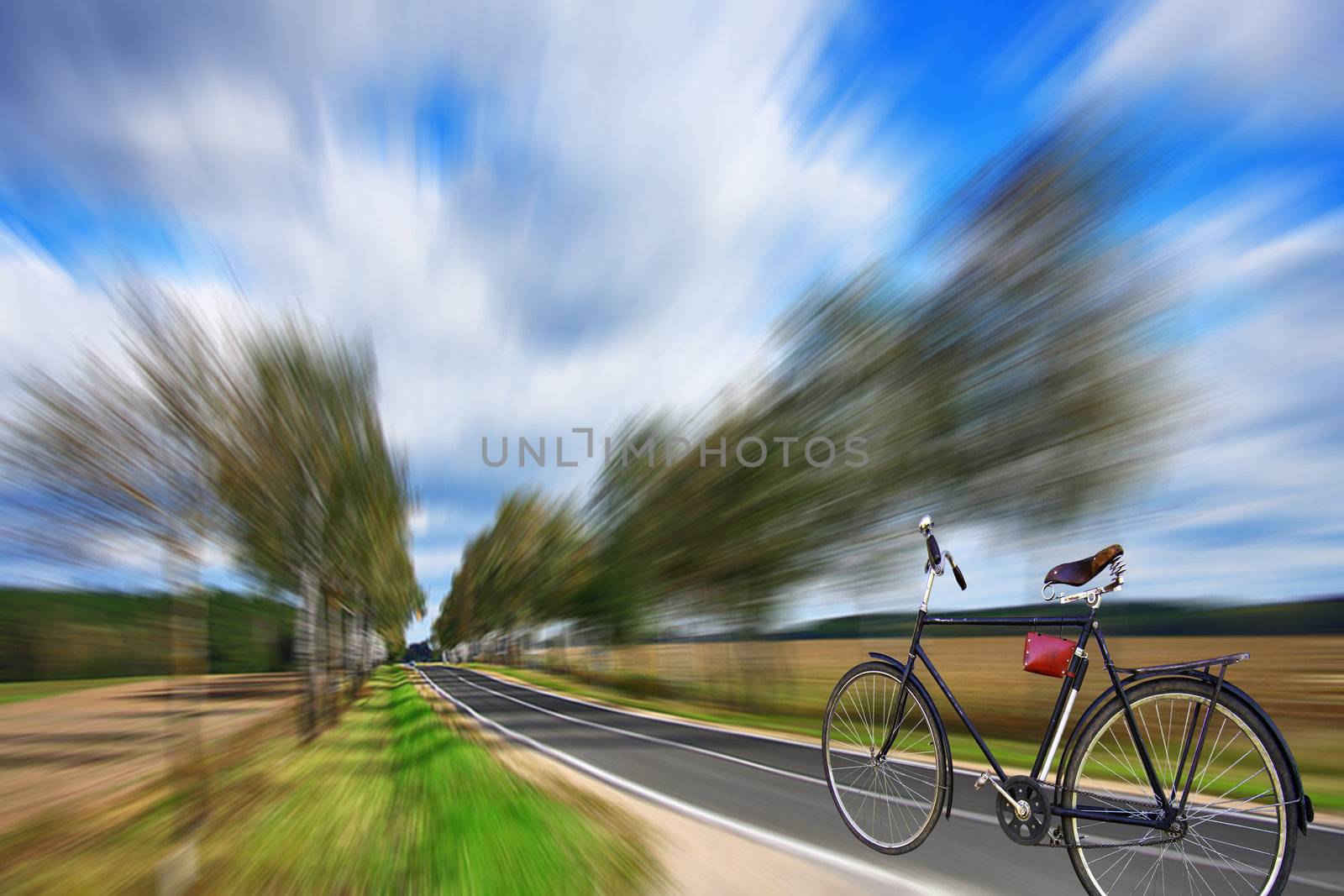 The bicycle quickly rushes on a highway. Day