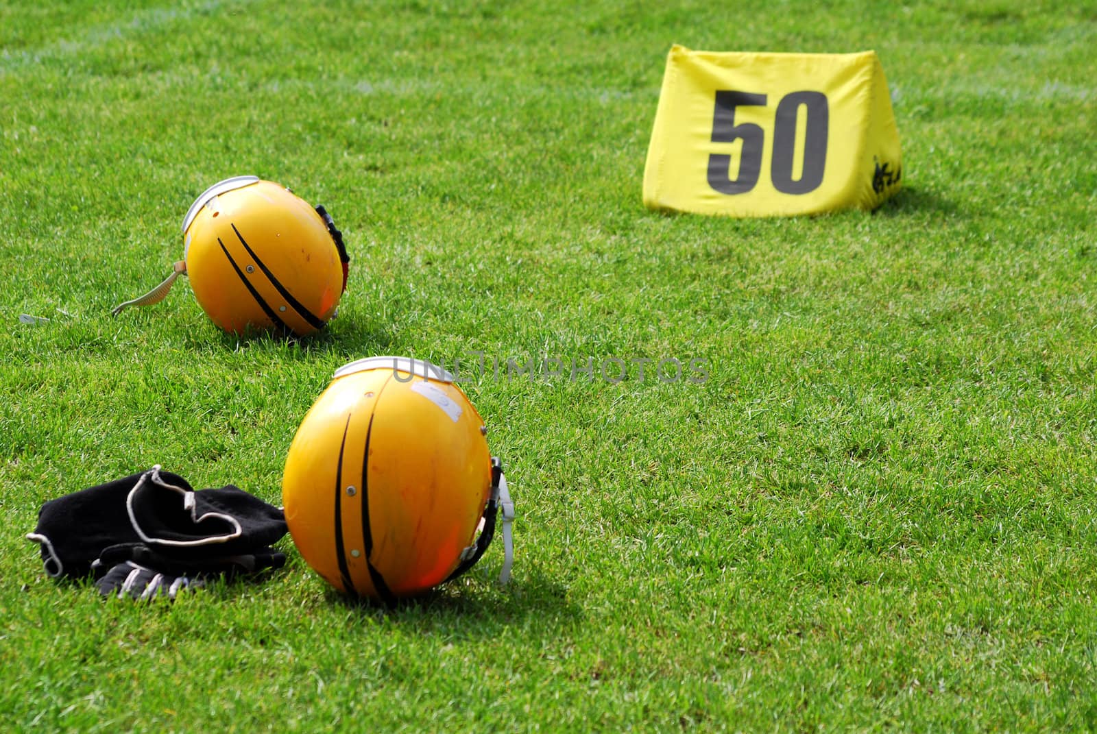 American football helmet and equipment on field